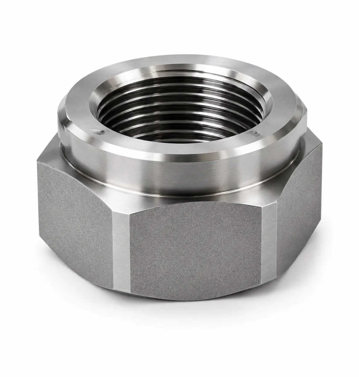 Machined nut with internal threads on a white surface